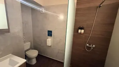 a bathroom with a toilet and a shower stall at Monastiraki 509 Central Suite in Athens