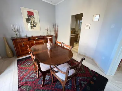 a dining room with a wooden table and chairs at A Stroll to the Acropolis - By Athenian Homes in Athens