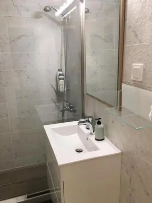 a bathroom with a white sink and a shower at A Stroll to the Acropolis - By Athenian Homes in Athens