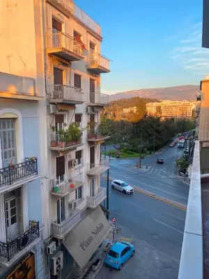 a blue car is parked in front of a building at A Stroll to the Acropolis - By Athenian Homes in Athens