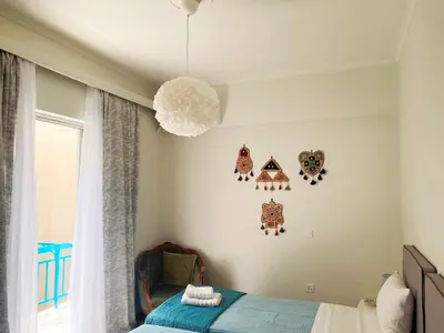 a bedroom with a bed and a pendant light at A Stroll to the Acropolis - By Athenian Homes in Athens