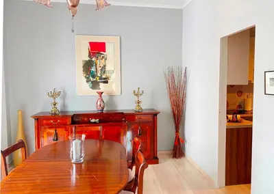a dining room with a wooden table and a kitchen at A Stroll to the Acropolis - By Athenian Homes in Athens