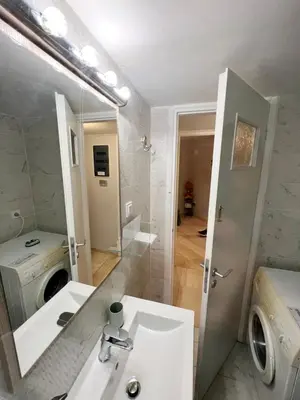 a bathroom with a sink and a washing machine at A Stroll to the Acropolis - By Athenian Homes in Athens