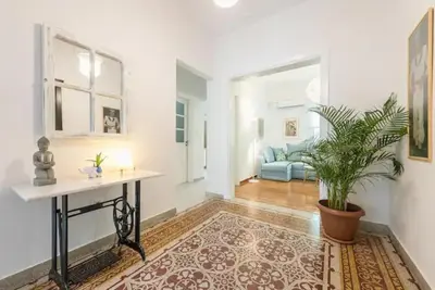 a living room with a table and a potted plant at Casa Pamisou near Attiki metro station in Athens