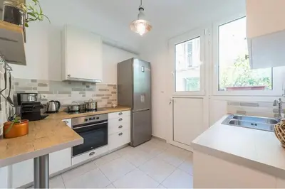 a kitchen with a refrigerator and a stove top oven at Casa Pamisou near Attiki metro station in Athens