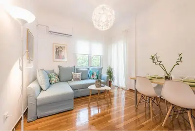 a living room with a couch and a table at Casa Pamisou near Attiki metro station in Athens