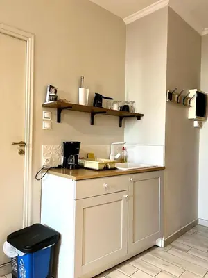 a kitchen with a counter and a white refrigerator at Monastiraki 312 SuperHost Hub in Athens