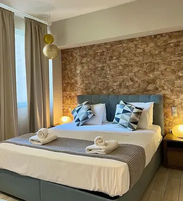 a bedroom with a bed with towels on it at Monastiraki 312 SuperHost Hub in Athens