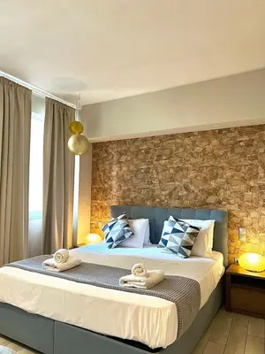 a bedroom with a large bed with towels on it at Monastiraki 312 SuperHost Hub in Athens
