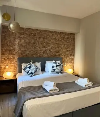 a bedroom with a large bed with towels on it at Monastiraki 312 SuperHost Hub in Athens