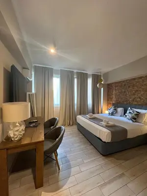 a hotel room with a bed and a table and a desk at Monastiraki 312 SuperHost Hub in Athens