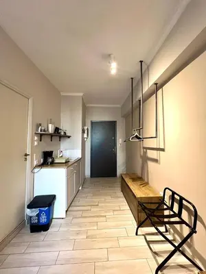 a room with a kitchen with a bench and a door at Monastiraki 312 SuperHost Hub in Athens