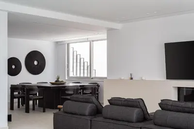 a living room with a couch and a table at Black Stone Villa in Sounio