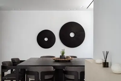 a dining room with a black table and black chairs at Black Stone Villa in Sounio
