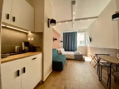 a kitchen and a living room with a table at Monastiraki 306 SuperHost Hub in Athens