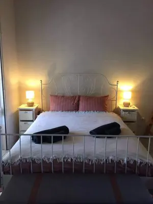 a bedroom with a large bed with two night stands at Little Beach Chalet in Saronida