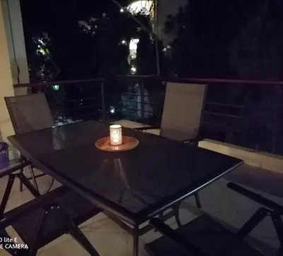 a candle sitting on top of a black table at Little Beach Chalet in Saronida