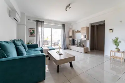 a living room with blue couches and a table at Modern spacious apartment located in Piraeus (B8) in Piraeus