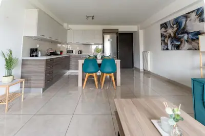 a kitchen with a table and chairs in a room at Modern spacious apartment located in Piraeus (B8) in Piraeus