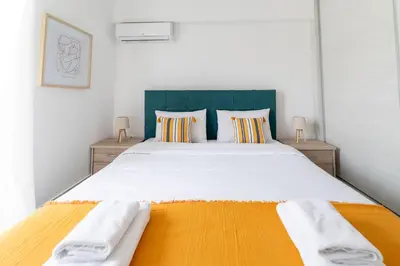 a bedroom with a large white bed with two pillows at Modern spacious apartment located in Piraeus (B8) in Piraeus
