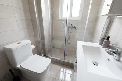 a bathroom with a shower and a toilet and a sink at Modern spacious apartment located in Piraeus (B8) in Piraeus