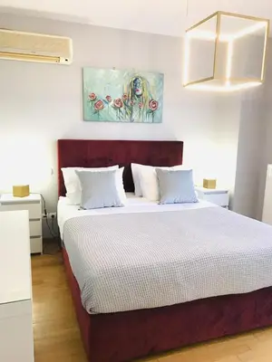 a bedroom with a large bed with white sheets at Beautiful maisonette with a view to the mountains and the sea in Aghia Marina