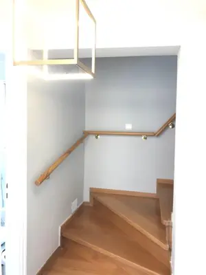 a stairwell with a stair railing and a light at Beautiful maisonette with a view to the mountains and the sea in Aghia Marina