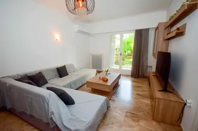 a living room with a couch and a table at Filoxenia Apartment Athens in Athens