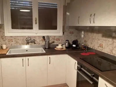 a kitchen with white cabinets and a sink at Filoxenia Apartment Athens in Athens