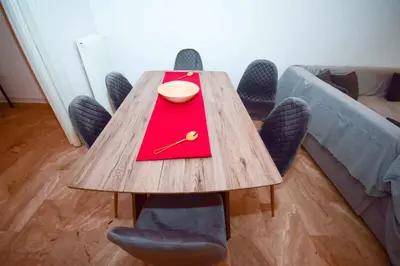 a wooden table with chairs and a bowl on it at Filoxenia Apartment Athens in Athens