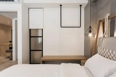 a bedroom with a white bed and two pictures on the wall at Chic Apartment - Strolling to the Athenian streets in Athens