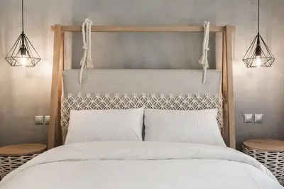 a bedroom with a bed with two lights above it at Chic Apartment - Strolling to the Athenian streets in Athens