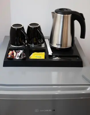a counter with a coffee pot and a tea kettle at Olvia Suites in Athens