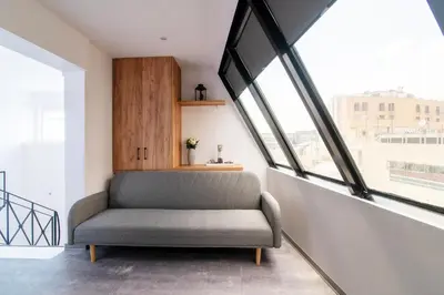 a chair in a room with large windows at Olvia Suites in Athens