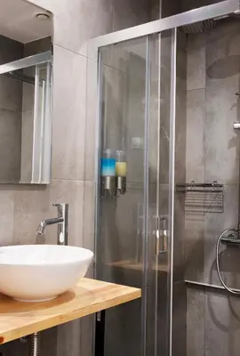 a bathroom with a sink and a shower at Olvia Suites in Athens