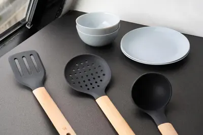 a table with two spatulas and a plate and a bowl at Olvia Suites in Athens
