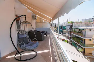 a balcony with a swing on a building at Pnyka Apartment 3 in Athens