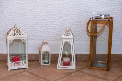 four small white lanterns sitting next to a wall at Pnyka Apartment 3 in Athens