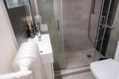 a bathroom with a shower with a toilet and a sink at Pnyka Apartment 3 in Athens
