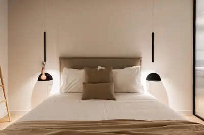 a bedroom with a large bed with white sheets and pillows at Marvelous 2BR Apartments with balcony by UPSTREET in Athens