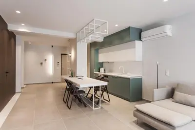 a kitchen and living room with a table and a couch at Marvelous 2BR Apartments with balcony by UPSTREET in Athens