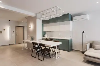 a kitchen with a table and chairs and a couch at Marvelous 2BR Apartments with balcony by UPSTREET in Athens