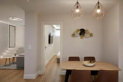 a dining room and living room with a table and chairs at Central & Comfy apartment 2mins walking from metro in Athens