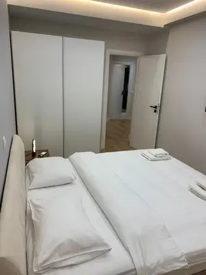 a white bed with two pillows on top of it at Central & Comfy apartment 2mins walking from metro in Athens