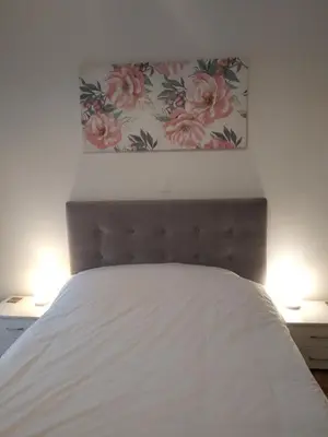 a bedroom with a white bed with two lamps at Lovely apartment next to Syggrou Fix metro station in Athens