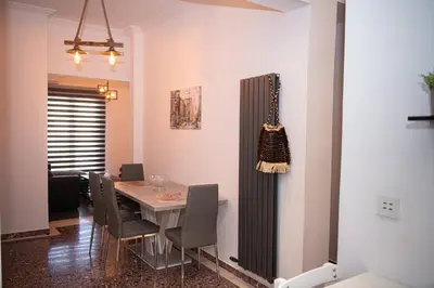 a dining room with a table and chairs at Sophia’s place in Piraeus
