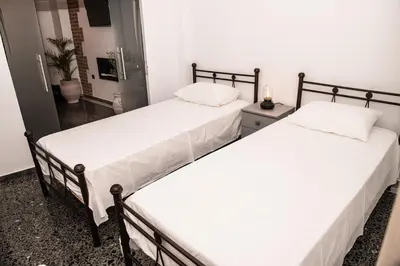 two beds sitting next to each other in a room at Sophia’s place in Piraeus