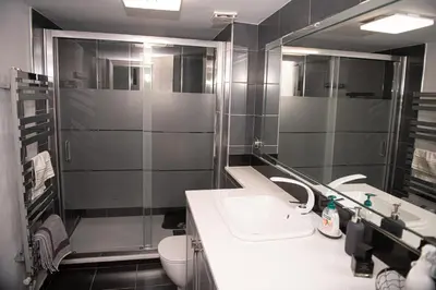 a bathroom with a sink and a shower and a toilet at Sophia’s place in Piraeus