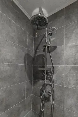 a shower with a shower head in a bathroom at Phaedrus Living: City Center Executive Flat Stadiou in Athens