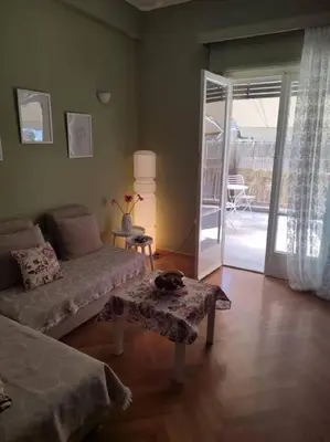 a living room with a bed and a sliding glass door at lovely penthouse at the center! in Athens